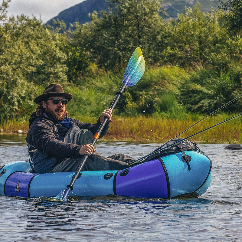 Zachary Scott Carothers paddles a raft while fishing