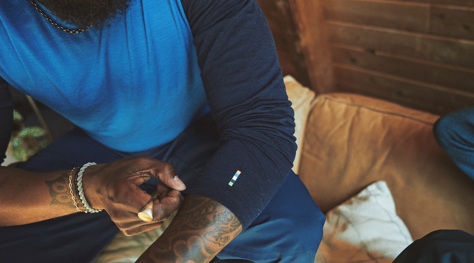 Man adjusting the sleeves on his base layer top.